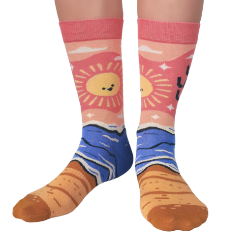 Women's crew socks with the phrase 'Live Laugh Leave Me Alone' in bold lettering and a colorful beach-themed design from Uptown Sox.